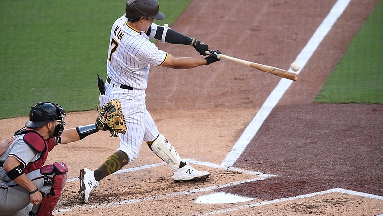 Apr 3, 2021; San Diego, California, USA; San Diego Padres second baseman Ha-seong Kim (7) hits an RBI single during the first inning against the Arizona Diamondbacks at Petco Park. Mandatory Credit: Orlando Ramirez-USA TODAY Sports