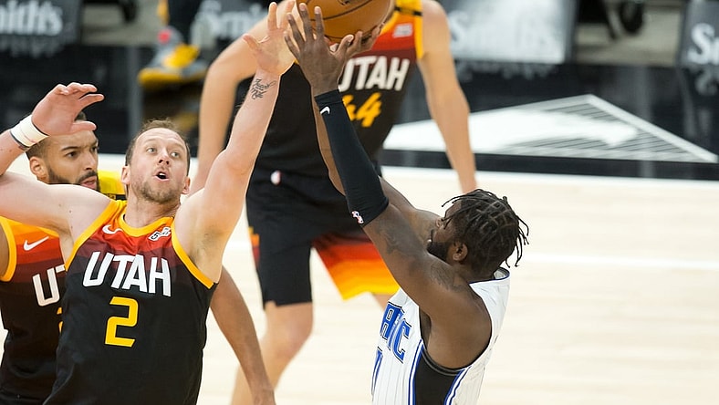 Apr 3, 2021; Salt Lake City, Utah, USA; Orlando Magic forward James Ennis III (right) shoots the ball against Utah Jazz forward Joe Ingles (2) during the first quarter at Vivint Smart Home Arena. Mandatory Credit: Russell Isabella-USA TODAY Sports