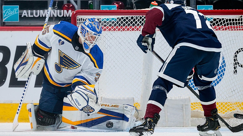 Apr 3, 2021; Denver, Colorado, USA; St. Louis Blues goaltender Ville Husso (35) makes a save ahead of Colorado Avalanche right wing Joonas Donskoi (72) in the first period at Ball Arena. Mandatory Credit: Isaiah J. Downing-USA TODAY Sports