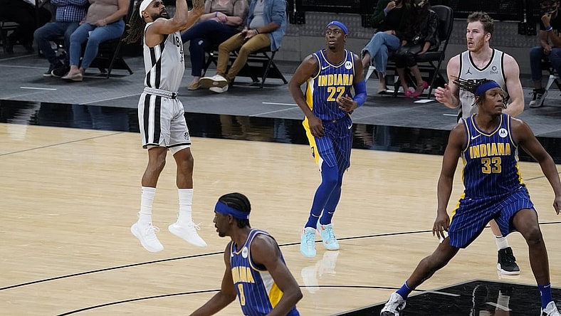 Apr 3, 2021; San Antonio, Texas, USA; San Antonio Spurs guard Patty Mills (8) shoots a three pointer as Indiana Pacers guard Caris LeVert (22) looks on in the second quarter at AT&T Center. Mandatory Credit: Scott Wachter-USA TODAY Sports