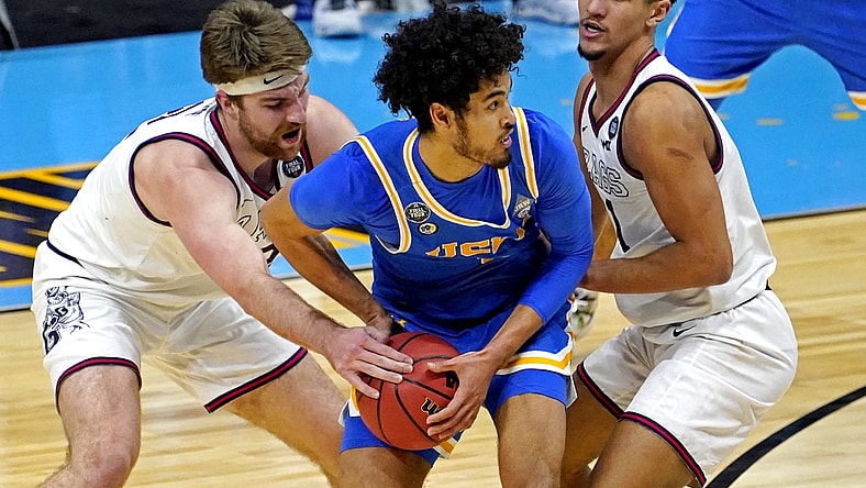 Apr 3, 2021; Indianapolis, Indiana, USA; UCLA Bruins guard Johnny Juzang (3) handles the ball against Gonzaga Bulldogs forward Drew Timme (2) and guard Jalen Suggs (1) during the second half in the national semifinals of the Final Four of the 2021 NCAA Tournament at Lucas Oil Stadium. Mandatory Credit: Robert Deutsch-USA TODAY Sports