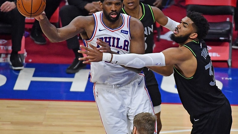 Apr 3, 2021; Philadelphia, Pennsylvania, USA; Philadelphia 76ers center Joel Embiid (left) passes the ball against Minnesota Timberwolves center Karl-Anthony Towns (32) during the fourth quarter at Wells Fargo Center. Mandatory Credit: Eric Hartline-USA TODAY Sports