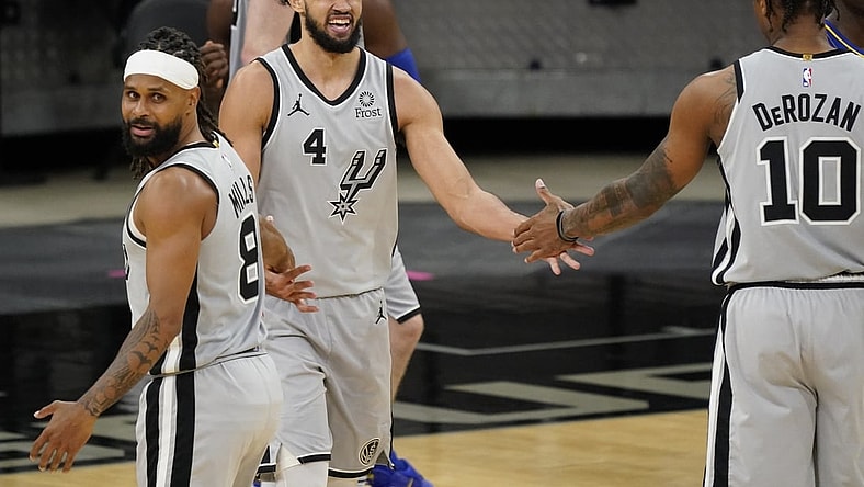 Apr 3, 2021; San Antonio, Texas, USA; San Antonio Spurs guard Derrick White (4) congraluated by guard Patty Mills (8) and forward DeMar DeRozan (10) after scoring and drawing foul in the third quarter of the game agains the Indiana Pacers at AT&T Center. Mandatory Credit: Scott Wachter-USA TODAY Sports