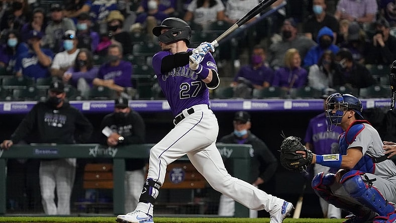 Apr 3, 2021; Denver, Colorado, USA; Colorado Rockies shortstop Trevor Story (27) hits a RBI double against the Los Angeles Dodgers in the eighth inning at Coors Field. Mandatory Credit: Ron Chenoy-USA TODAY Sports