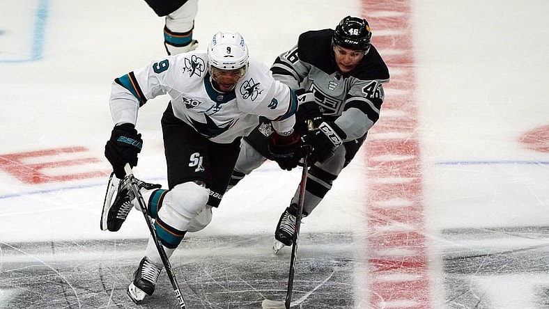 Apr 3, 2021; Los Angeles, California, USA; San Jose Sharks left wing Evander Kane (9) moves the puck against Los Angeles Kings center Blake Lizotte (46) during the third period at Staples Center. Mandatory Credit: Gary A. Vasquez-USA TODAY Sports