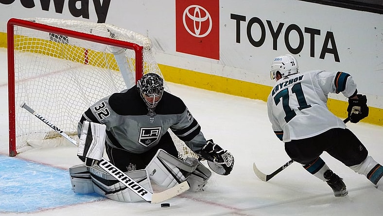 Apr 3, 2021; Los Angeles, California, USA; Los Angeles Kings goaltender Jonathan Quick (32) blocks a shot against San Jose Sharks defenseman Nikolai Knyzhov (71) during the third period at Staples Center. Mandatory Credit: Gary A. Vasquez-USA TODAY Sports