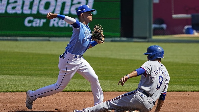 Apr 4, 2021; Kansas City, Missouri, USA; Kansas City Royals shortstop Nicky Lopez (8) throws to first base after forcing out Texas Rangers third baseman Isiah Kiner-Falefa (9) during the third inning at Kauffman Stadium. Mandatory Credit: Jay Biggerstaff-USA TODAY Sports