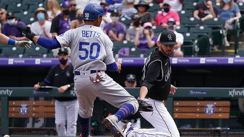 Apr 4, 2021; Denver, Colorado, USA; Los Angeles Dodgers right fielder Mookie Betts (50) scores on Colorado Rockies starting pitcher Austin Gomber (26) in the first inning at Coors Field. Mandatory Credit: Ron Chenoy-USA TODAY Sports