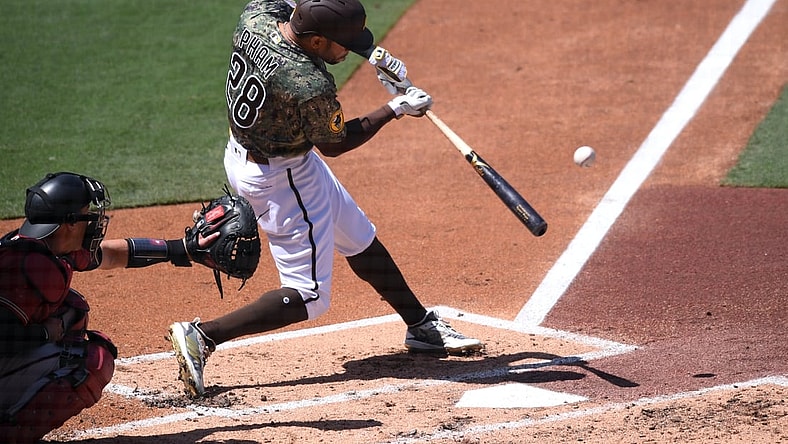 Apr 4, 2021; San Diego, California, USA; San Diego Padres center fielder Tommy Pham (28) singles against the Arizona Diamondbacks during the second inning at Petco Park. Mandatory Credit: Orlando Ramirez-USA TODAY Sports