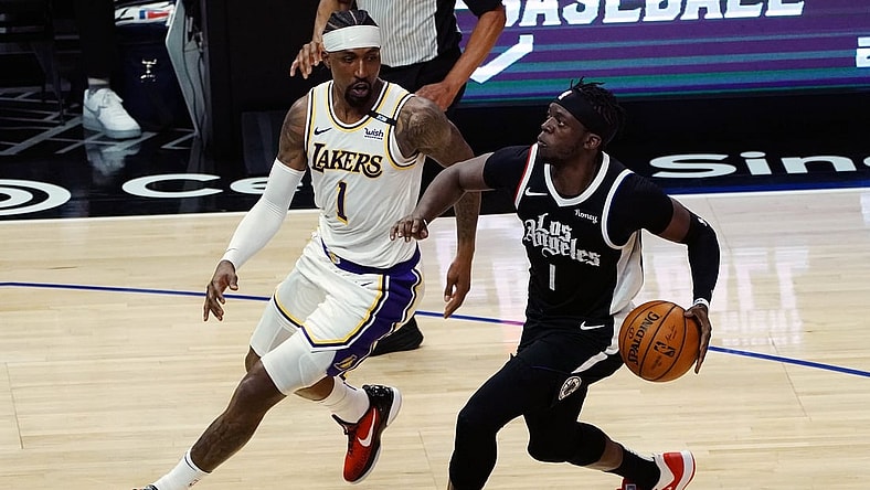 Apr 4, 2021; Los Angeles, California, USA; Los Angeles Clippers guard Reggie Jackson (1) moves to the basket against Los Angeles Lakers guard Kentavious Caldwell-Pope (1) during the first half at Staples Center. Mandatory Credit: Gary A. Vasquez-USA TODAY Sports