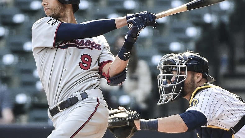 Apr 4, 2021; Milwaukee, Wisconsin, USA; Minnesota Twins shortstop Andrelton Simmons (9) hits a triple to drive in a run in the eighth inning against the Milwaukee Brewers at American Family Field. Mandatory Credit: Benny Sieu-USA TODAY Sports