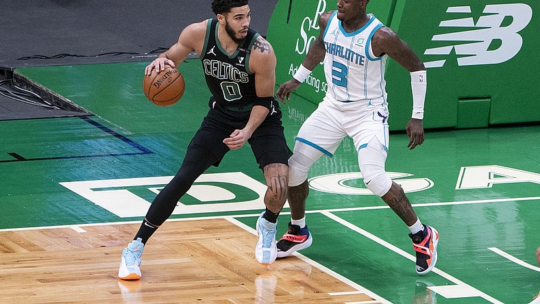 Apr 4, 2021; Boston, Massachusetts, USA;  Boston Celtics power forward Jayson Tatum (0) dribbles the ball against Charlotte Hornets shooting guard Terry Rozier (3) defending during the first quarter at TD Garden. Mandatory Credit: Gregory Fisher-USA TODAY Sports