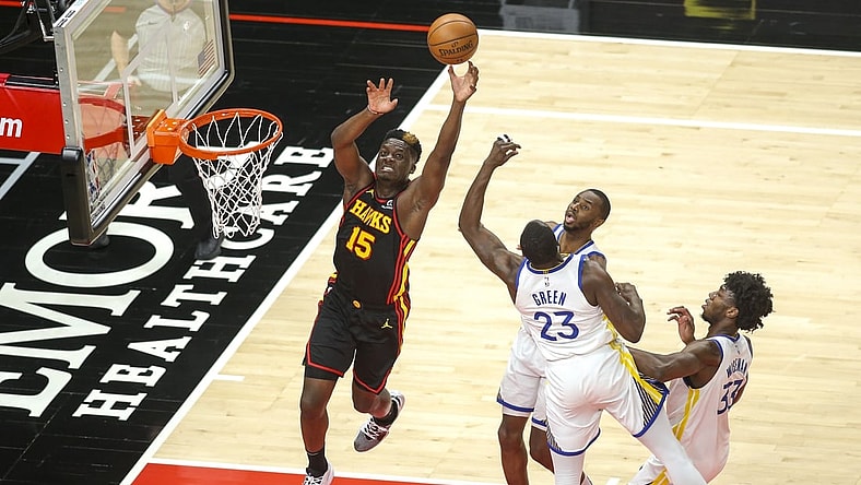 Apr 4, 2021; Atlanta, Georgia, USA; Atlanta Hawks center Clint Capela (15) goes up for an alley oop in front of Golden State Warriors forward Andrew Wiggins (22) and forward Draymond Green (23) and center James Wiseman (33) in the first quarter at State Farm Arena. Mandatory Credit: Brett Davis-USA TODAY Sports
