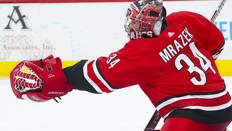 Apr 4, 2021; Raleigh, North Carolina, USA;  Carolina Hurricanes goaltender Petr Mrazek (34) makes a second period glove save against the Dallas Stars at PNC Arena. Mandatory Credit: James Guillory-USA TODAY Sports