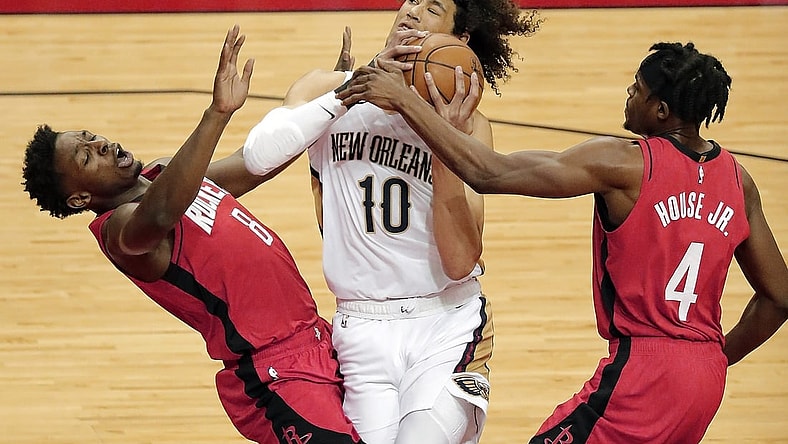 Apr 4, 2021; Houston, TX, USA;  New Orleans Pelicans center Jaxson Hayes (10) drives to basket past Houston Rockets forward Danuel House Jr. (4) as forward Jae'Sean Tate (8) is called for a block during the first quarter at Toyota Center.  Mandatory Credit: Bob Levey/Pool Photo-USA TODAY Sports