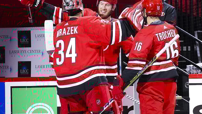 Apr 4, 2021; Raleigh, North Carolina, USA;  Carolina Hurricanes goaltender Petr Mrazek (34) and defenseman Jaccob Slavin (74) and center Vincent Trocheck (16) celebrate the win against the Dallas Stars at PNC Arena. Mandatory Credit: James Guillory-USA TODAY Sports