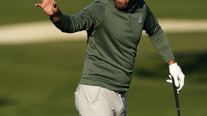 Apr 5, 2021; Augusta, Georgia, USA; Defending champion Dustin Johnson catches a ball at the practice facility as he prepares for The Masters golf tournament at Augusta National Golf Club. Mandatory Credit: Rob Schumacher-USA TODAY Sports