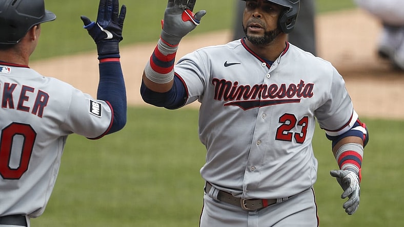 Apr 5, 2021; Detroit, Michigan, USA; Minnesota Twins designated hitter Nelson Cruz (23) celebrates with left fielder Brent Rooker (50) after hitting a solo home run during the fifth inning against the Detroit Tigers at Comerica Park. Mandatory Credit: Raj Mehta-USA TODAY Sports