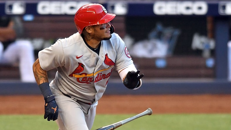 Apr 5, 2021; Miami, Florida, USA; St. Louis Cardinals catcher Yadier Molina (4) hits a double against the Miami Marlins in the first inning at loanDepot Park. Mandatory Credit: Jim Rassol-USA TODAY Sports