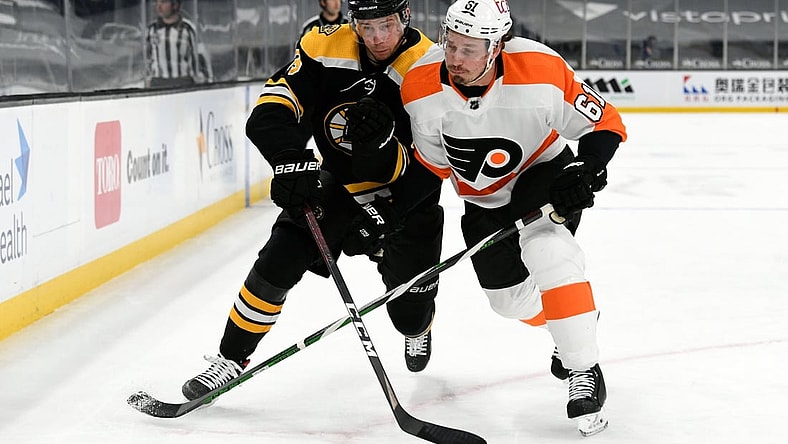 Apr 5, 2021; Boston, Massachusetts, USA; Boston Bruins center Charlie Coyle (13) and Philadelphia Flyers defenseman Justin Braun (61) compete for position during the first period at the TD Garden. Mandatory Credit: Brian Fluharty-USA TODAY Sports