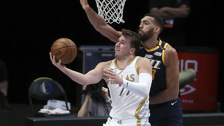 Apr 5, 2021; Dallas, Texas, USA; Dallas Mavericks guard Luka Doncic (77) shoots as Utah Jazz center Rudy Gobert (27) defends during the first half against the Utah Jazz at American Airlines Center. Mandatory Credit: Kevin Jairaj-USA TODAY Sports