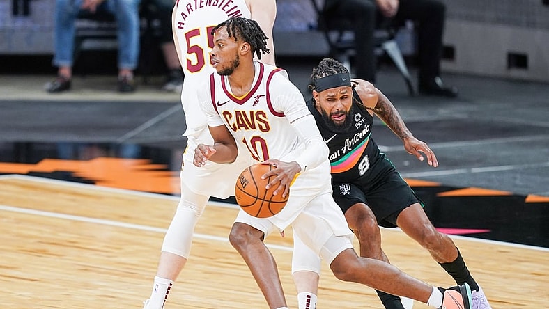 Apr 5, 2021; San Antonio, Texas, USA;  Cleveland Cavaliers guard Darius Garland (10) dribbles past San Antonio Spurs guard Patty Mills (8) in the first half at the AT&T Center. Mandatory Credit: Daniel Dunn-USA TODAY Sports