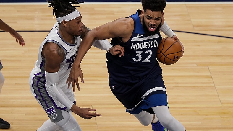 Apr 5, 2021; Minneapolis, Minnesota, USA; Minnesota Timberwolves center Karl-Anthony Towns (32) drives against Sacramento Kings center Richaun Holmes (22) in the second quarter at Target Center. Mandatory Credit: Brad Rempel-USA TODAY Sports