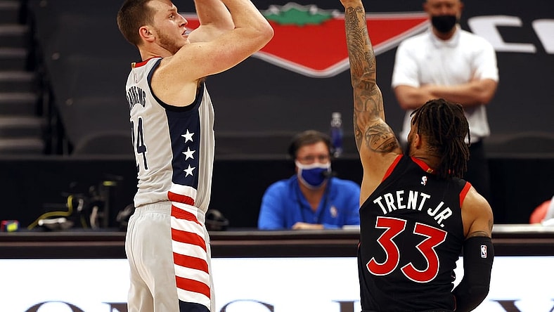 Apr 5, 2021; Tampa, Florida, USA;  Washington Wizards forward Garrison Mathews (24) shoots a three point basket over Toronto Raptors guard Gary Trent Jr. (33) during the first half at Amalie Arena. Mandatory Credit: Kim Klement-USA TODAY Sports
