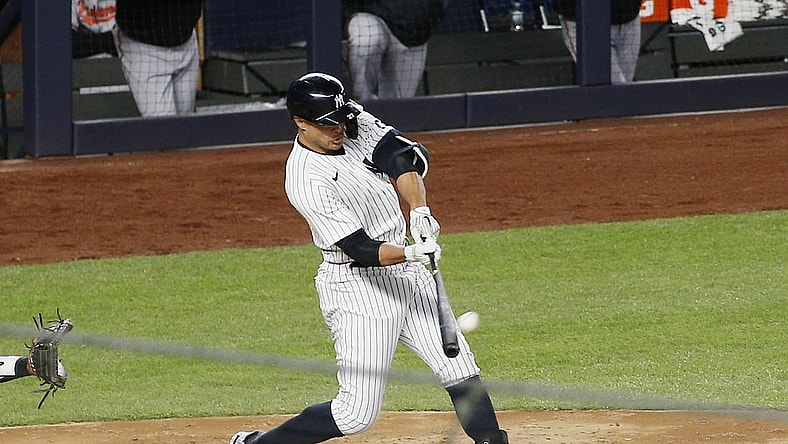 Apr 5, 2021; Bronx, New York, USA; New York Yankees designated hitter Giancarlo Stanton (27) hits a grand slam home run against the Baltimore Orioles during the fifth inning at Yankee Stadium. Mandatory Credit: Andy Marlin-USA TODAY Sports
