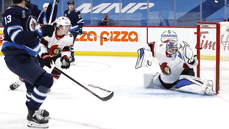 Apr 5, 2021; Winnipeg, Manitoba, CAN;  Winnipeg Jets left wing Pierre-Luc Dubois (13) scores on Ottawa Senators goaltender Anton Forsberg (31) in the second period at Bell MTS Place. Mandatory Credit: James Carey Lauder-USA TODAY Sports