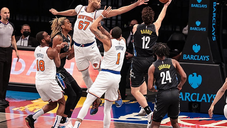 Apr 5, 2021; Brooklyn, New York, USA; Brooklyn Nets forward Joe Harris (12) shoots the ball against New York Knicks center Taj Gibson (67) and forward Obi Toppin (1) during the second half at Barclays Center. Mandatory Credit: Vincent Carchietta-USA TODAY Sports