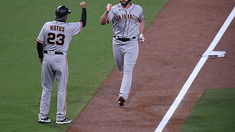 Apr 5, 2021; San Diego, California, USA; San Francisco Giants left fielder Darin Ruf (R) is congratulated by third base coach Ron Wotus (23) after hitting a home run against the San Diego Padres during the second inning at Petco Park. Mandatory Credit: Orlando Ramirez-USA TODAY Sports