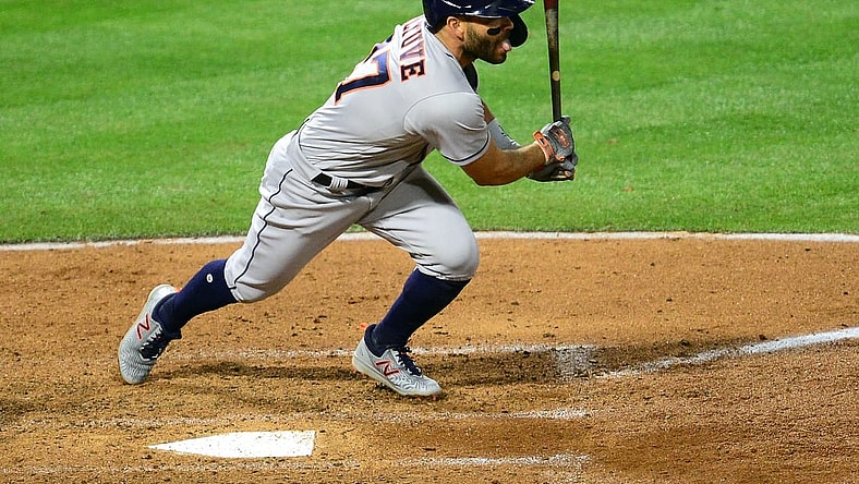 Apr 5, 2021; Anaheim, California, USA; Houston Astros second baseman Jose Altuve (27) hits an RBI single against the Los Angeles Angels during the fourth inning  at Angel Stadium. Mandatory Credit: Gary A. Vasquez-USA TODAY Sports
