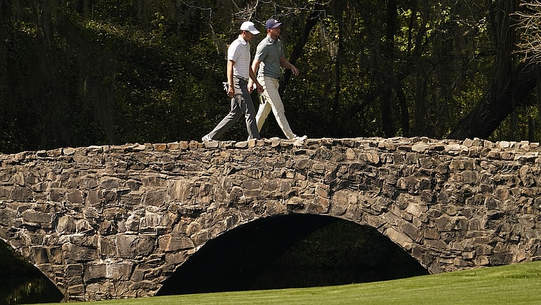 Apr 6, 2021; Augusta, Georgia, USA; Jordan Spieth and Daniel Berger walk on the Nelson Bridge on the 13th hole during a practice round for The Masters golf tournament at Augusta National Golf Club. Mandatory Credit: Rob Schumacher-USA TODAY Sports