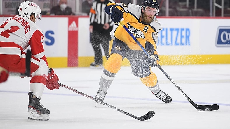 Apr 6, 2021; Detroit, Michigan, USA; Nashville Predators defenseman Mattias Ekholm (14) passes as Detroit Red Wings center Luke Glendening (41) defends during the first period at Little Caesars Arena. Mandatory Credit: Tim Fuller-USA TODAY Sports