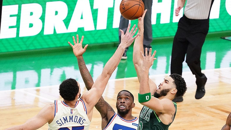 Apr 6, 2021; Boston, Massachusetts, USA; Boston Celtics forward Jayson Tatum (0) shoots against Philadelphia 76ers guard Shake Milton (18) and guard Ben Simmons (25) in the second quarter at TD Garden. Mandatory Credit: David Butler II-USA TODAY Sports