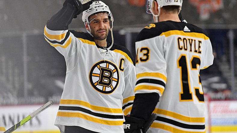 Apr 6, 2021; Philadelphia, Pennsylvania, USA; Boston Bruins center Patrice Bergeron (37) and center Charlie Coyle (13) celebrate win against the Philadelphia Flyers at Wells Fargo Center. Mandatory Credit: Eric Hartline-USA TODAY Sports