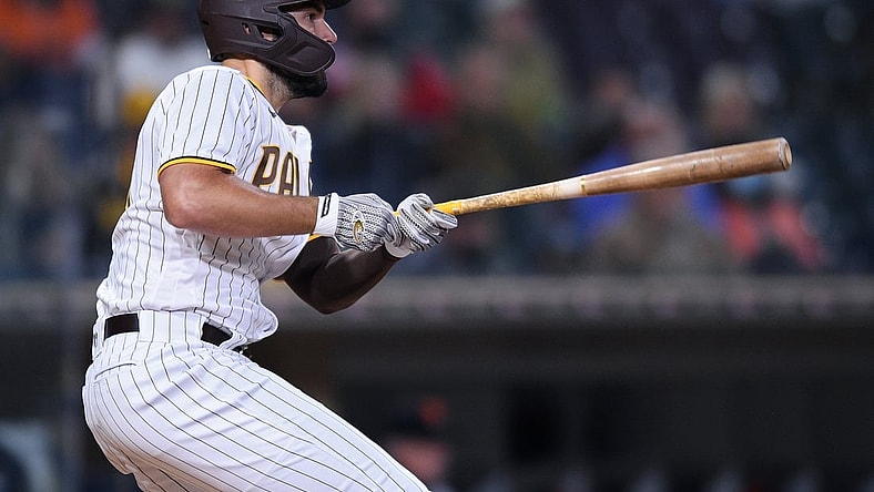 Apr 6, 2021; San Diego, California, USA; San Diego Padres first baseman Eric Hosmer (30) watches his RBI single during the third inning against the San Francisco Giants at Petco Park. Mandatory Credit: Orlando Ramirez-USA TODAY Sports
