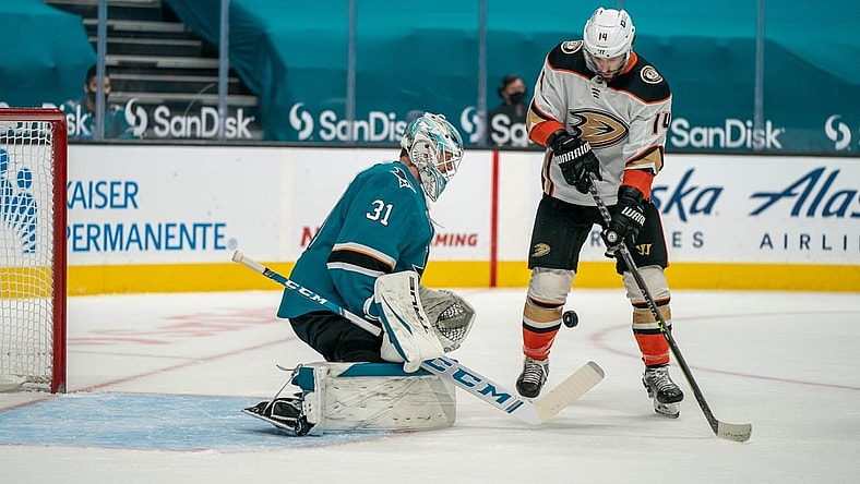 Apr 6, 2021; San Jose, California, USA;  Anaheim Ducks center Adam Henrique (14) attempt to shoot the puck against San Jose Sharks goaltender Martin Jones (31) during the first period at SAP Center at San Jose. Mandatory Credit: Neville E. Guard-USA TODAY Sports