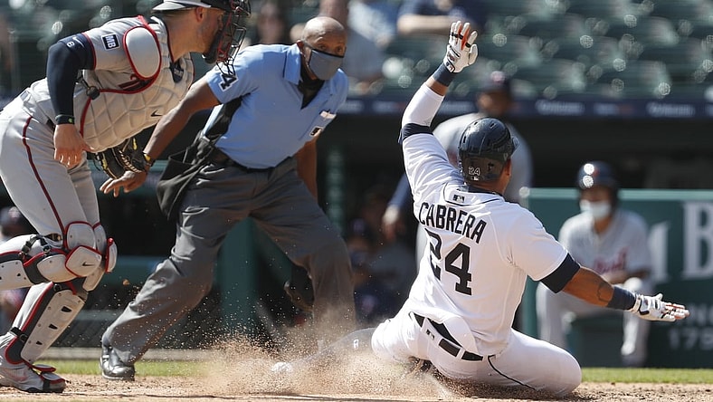 Apr 7, 2021; Detroit, Michigan, USA; Detroit Tigers first baseman Miguel Cabrera (24) slides into home plate after already getting tagged out by Minnesota Twins catcher Mitch Garver (left) during the sixth inning at Comerica Park. Mandatory Credit: Raj Mehta-USA TODAY Sports