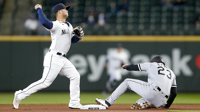 Apr 7, 2021; Seattle, Washington, USA; Seattle Mariners second baseman Ty France (23) attempts to turn a double play against Chicago White Sox third baseman Jake Lamb (23) during the first inning at T-Mobile Park. Mandatory Credit: Joe Nicholson-USA TODAY Sports