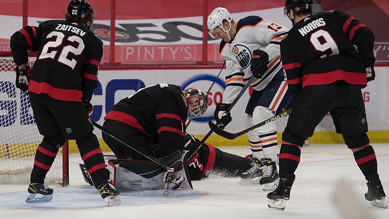 Apr 7, 2021; Ottawa, Ontario, CAN; Ottawa Senators goalie Marcus Hogberg (1) makes a save in front of Edmonton Oilers right wing Jesse Puljujarvi (13) in the first period at the Canadian Tire Centre. Mandatory Credit: Marc DesRosiers-USA TODAY Sports