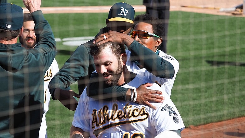 Apr 7, 2021; Oakland, California, USA; Oakland Athletics left fielder Tony Kemp (5) celebrates with first baseman Mitch Moreland (18) after Moreland hit an RBI single for a walk-off win against the Los Angeles Dodgers in the tenth inning at RingCentral Coliseum. Mandatory Credit: Kelley L Cox-USA TODAY Sports