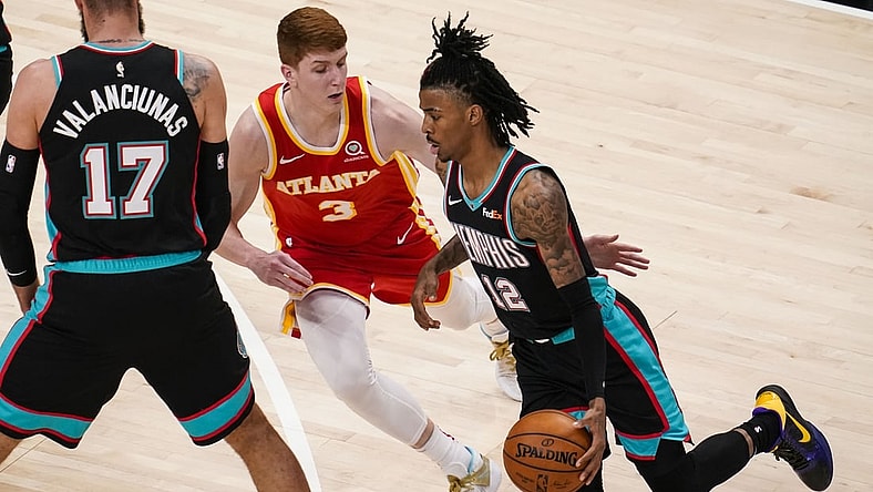 Apr 7, 2021; Atlanta, Georgia, USA; Memphis Grizzlies guard Ja Morant (12) tries to dribble past Atlanta Hawks guard Kevin Huerter (3) during the first quarter at State Farm Arena. Mandatory Credit: Dale Zanine-USA TODAY Sports