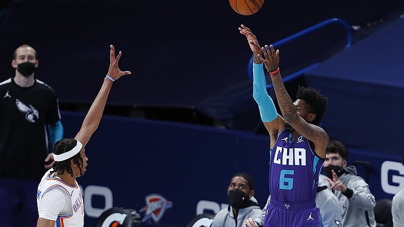Apr 7, 2021; Oklahoma City, Oklahoma, USA; Charlotte Hornets forward Jalen McDaniels (6) shoots a three point basket over Oklahoma City Thunder center Moses Brown (9) during the first quarter at Chesapeake Energy Arena. Mandatory Credit: Alonzo Adams-USA TODAY Sports