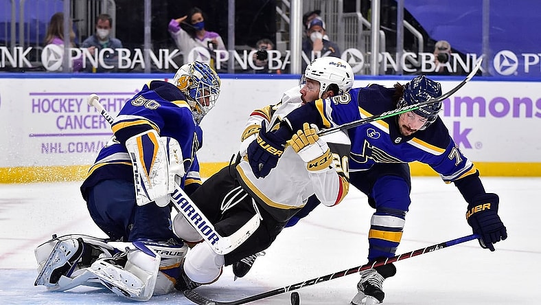 Apr 7, 2021; St. Louis, Missouri, USA;  St. Louis Blues goaltender Jordan Binnington (50) and defenseman Justin Faulk (72) defend the net against Vegas Golden Knights center Chandler Stephenson (20) during the first period at Enterprise Center. Mandatory Credit: Jeff Curry-USA TODAY Sports