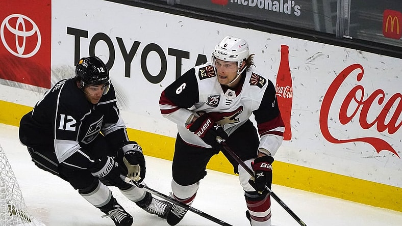 Apr 7, 2021; Los Angeles, California, USA; Arizona Coyotes defenseman Jakob Chychrun (6) moves the puck against Los Angeles Kings center Trevor Moore (12) during the first period at Staples Center. Mandatory Credit: Gary A. Vasquez-USA TODAY Sports