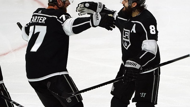 Apr 7, 2021; Los Angeles, California, USA; Los Angeles Kings center Jeff Carter (77) celebrates with defenseman Drew Doughty (8) his goal scored against the Arizona Coyotes during the third period at Staples Center. Mandatory Credit: Gary A. Vasquez-USA TODAY Sports