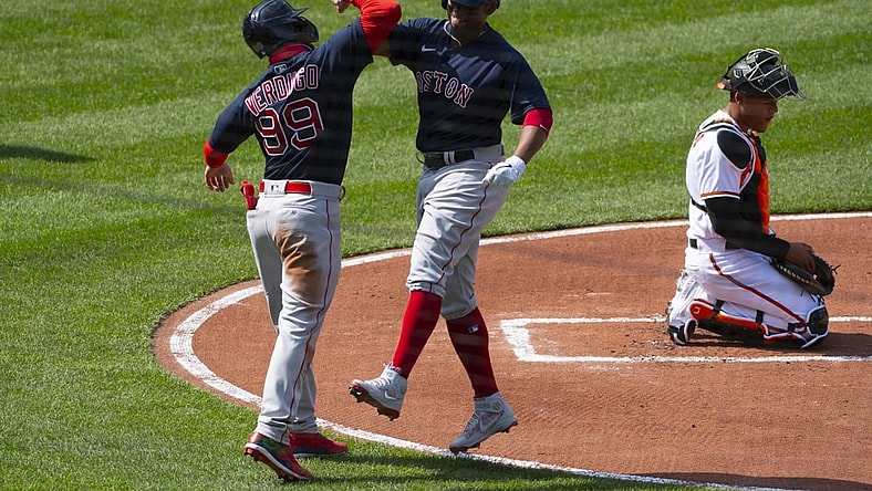 Apr 8, 2021; Baltimore, Maryland, USA;  Boston Red Sox third baseman Rafael Devers (11) celebrates with Boston Red Sox center fielder Alex Verdugo (99) at home plate after hitting a two run home run during the first inning as Baltimore Orioles catcher Pedro Severino (28) looks on at Oriole Park at Camden Yards. Mandatory Credit: Tommy Gilligan-USA TODAY Sports