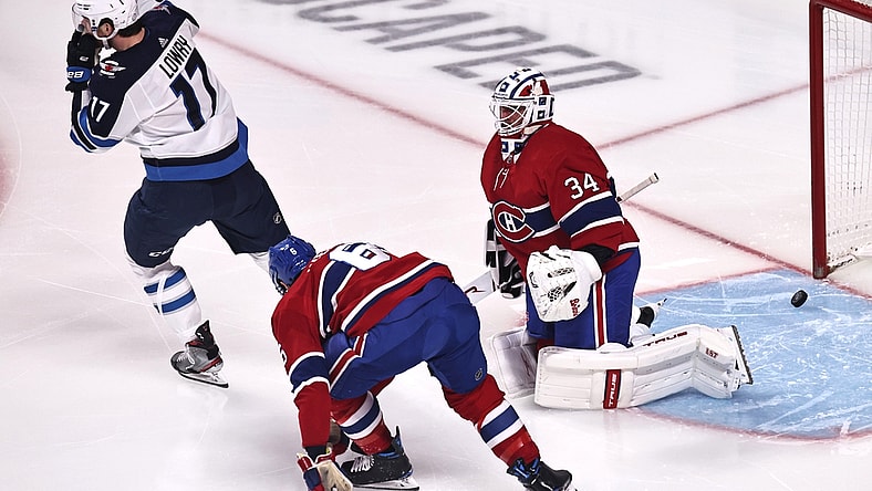 Apr 8, 2021; Montreal, Quebec, CAN; Winnipeg Jets left wing Adam Lowry (17) celebrates a goal by defenseman Josh Morrissey (not pictured) against Montreal Canadiens goaltender Jake Allen (34) and during the first period at Bell Centre. Mandatory Credit: Jean-Yves Ahern-USA TODAY Sports
